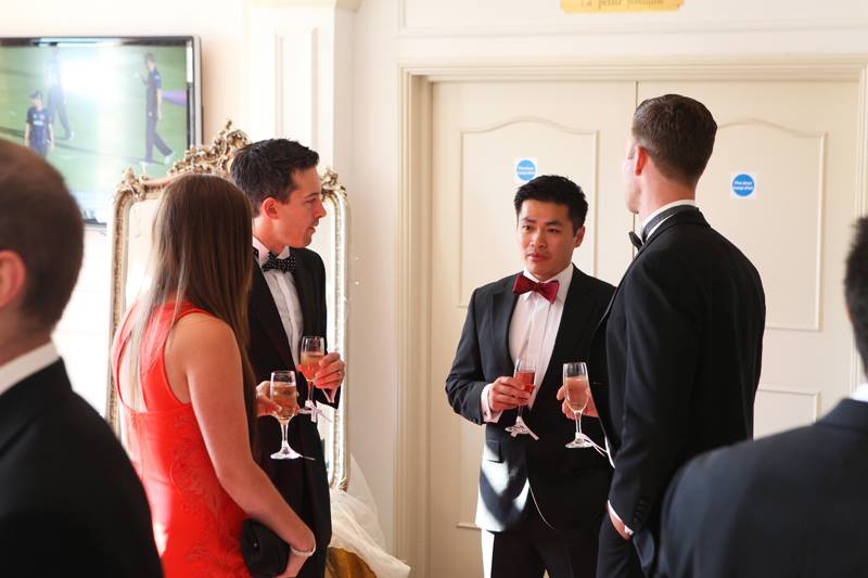 Patrick Cunningham and Wing Lai talking with others at the YBG Summer Ball 2014 